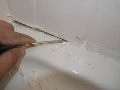 removing_caulk_with_screwdriver